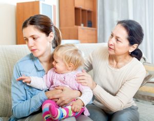 Parents problems. Mature woman comforting adult daughter with baby